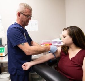 EBO MD provider performing in-office lab testing on patient