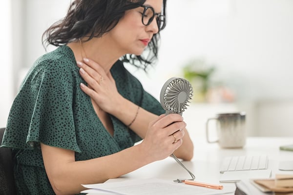 Young woman with hot flash from perimenopause