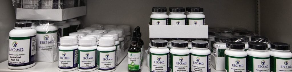 Rows of prescription medications and supplements arranged on a shelf