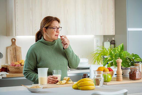 woman taking oral weight loss medication